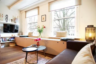 a living room with a couch and a table at Sonnenberg Canal View in Amsterdam