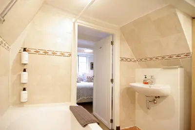 a bathroom with a sink and a tub and a toilet at Sonnenberg Canal View in Amsterdam