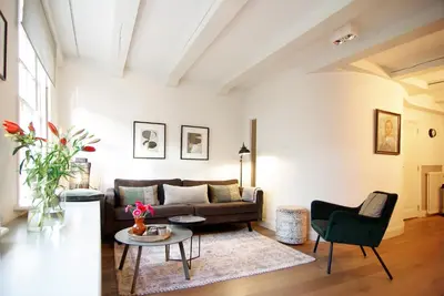 a living room with a couch and a table at Sonnenberg Canal View in Amsterdam