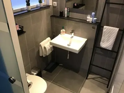 a bathroom with a sink and a toilet at Sunny Place in Zandvoort