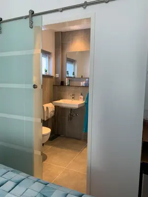 a bathroom with a toilet and a sink at Sunny Place in Zandvoort