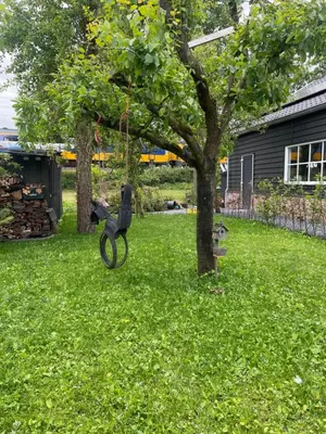 a statue of a horse hanging from a tree at Aan de Wiericke in Driebruggen