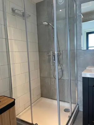 a shower with a glass door in a bathroom at Aan de Wiericke in Driebruggen