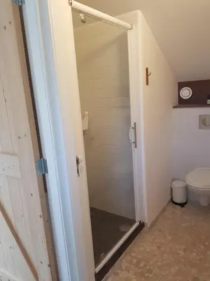 a bathroom with a shower and a toilet at Ecolodge de Parel Schoorl in Schoorl