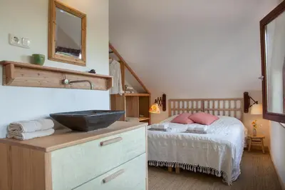 a bedroom with a bed and a sink in it at Ecolodge de Parel Schoorl in Schoorl