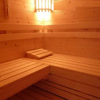 a wooden sauna with a bench in it at Ecolodge de Parel Schoorl in Schoorl