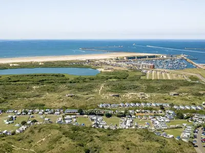 an aerial view of a parking lot next to the beach at Chalet Charlee in IJmuiden