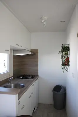 a kitchen with a sink and a counter top at Chalet Charlee in IJmuiden