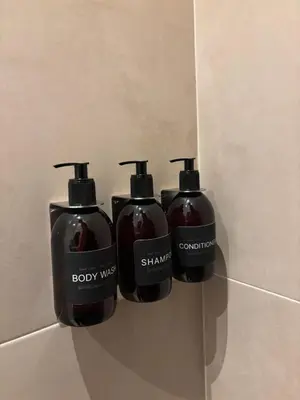 a group of three soap dispensers on a wall at Lovely small apartment in 'De Pijp' in Amsterdam