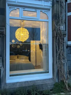 a reflection of a bed in a window at Lovely small apartment in 'De Pijp' in Amsterdam