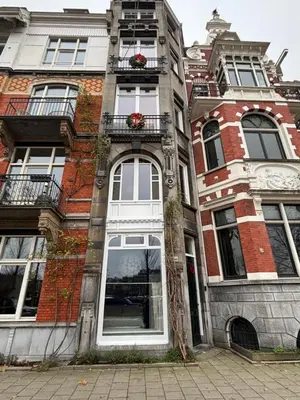 an apartment building with white windows and flowers on the balconies at Lovely small apartment in 'De Pijp' in Amsterdam