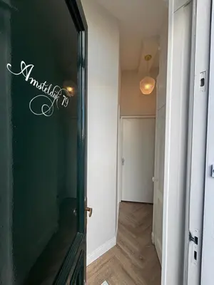 a hallway with a door to a room at Lovely small apartment in 'De Pijp' in Amsterdam