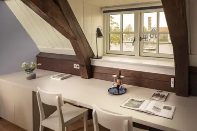 a room with a table and chairs and a window at Saenliefde in Wormer