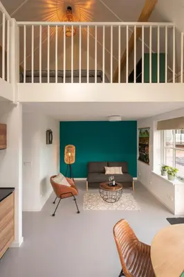 a living room with a couch and a table at Saenliefde in Wormer
