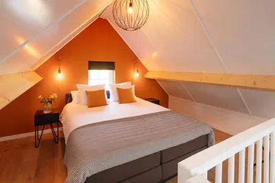 a bedroom with a bed in a attic at Saenliefde in Wormer