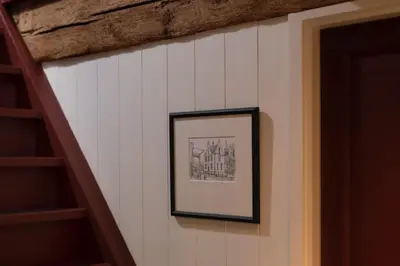 a picture hanging on a wall next to a staircase at Saenliefde in Wormer