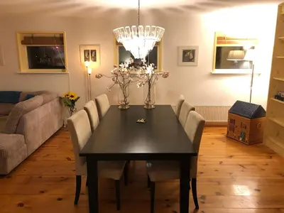 a dining room with a black table and chairs at Familiehuis Achter de Duijnhoeve Bakkum in Zuidbakkum