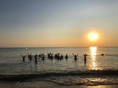 a group of people standing in the water at the beach at Familiehuis Achter de Duijnhoeve Bakkum in Zuidbakkum