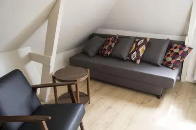 a living room with a couch and a table at Miriam's Suite Amsterdam in Amsterdam