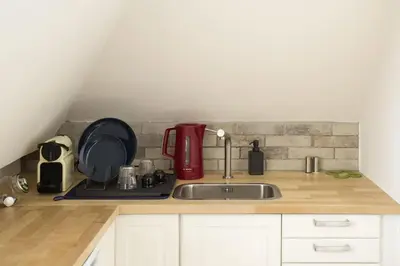 a kitchen counter with a sink and a red appliance at Miriam's Suite Amsterdam in Amsterdam