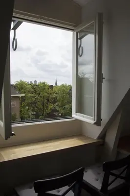 a window in a room with a wooden window sill at Miriam's Suite Amsterdam in Amsterdam