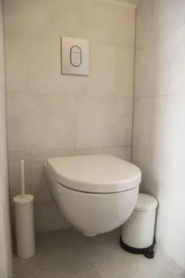 a bathroom with a white toilet and a roll of toilet paper at Miriam's Suite Amsterdam in Amsterdam