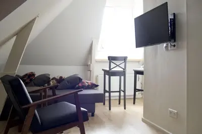 a living room with a couch and a table and chairs at Miriam's Suite Amsterdam in Amsterdam