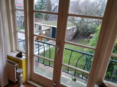 a window with a view of a yard at Bed & Bye Schiphol in Badhoevedorp