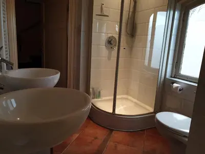 a bathroom with two sinks and a shower at Bed & Bye Schiphol in Badhoevedorp
