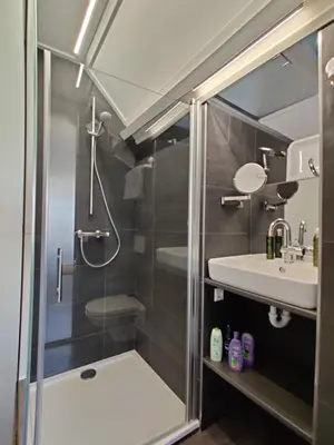 a bathroom with a shower and a sink at B&B Be Our Guest in Sint Maarten
