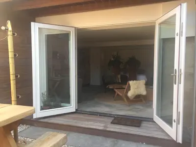 an open sliding glass door on a patio at Luxury Beach Studio Zandvoort in Zandvoort