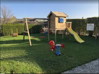 a small playground with a toy mouse in the grass at Ferienpark Vislust Haus De Graaf Niederlande Ijsselmeer in Wervershoof