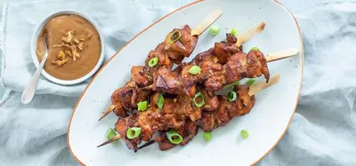 a plate of food with meat and chop sticks at Tamar in Katwijk aan Zee