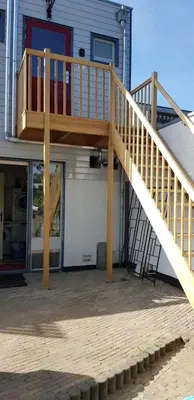 a wooden deck on the side of a house at Jabaki Red Studio in Hoofddorp