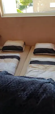 three beds sitting in a room with a window at Jabaki Red Studio in Hoofddorp