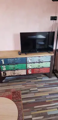 a tv sitting on top of a shelf with books at Jabaki Red Studio in Hoofddorp