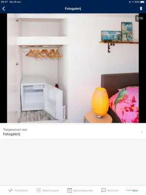 a room with a bed and a table and a shelf at little ibiza in Zandvoort