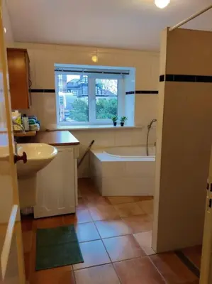 a bathroom with a tub and a sink and a bath tub at In het Centrum in Bergen