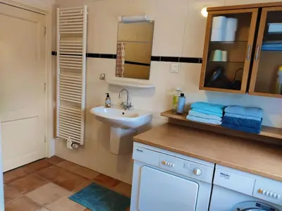 a bathroom with a sink and a toilet and a mirror at In het Centrum in Bergen