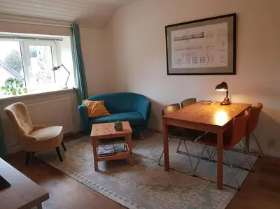 a living room with a table and a blue couch at In het Centrum in Bergen