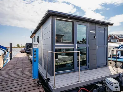 a tiny house on a dock on a boat at Harbour Lodge at Uitgeestermeer View in Uitgeest