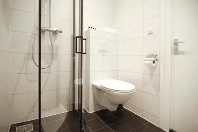 a bathroom with a toilet and a shower at Weber Hotel 117 in Amsterdam