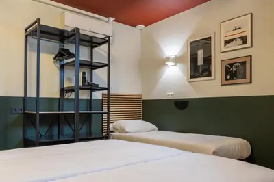 two beds in a room with two beds sidx sidx sidx at Weber Hotel 117 in Amsterdam