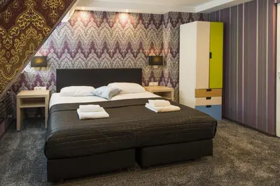 a bedroom with a large bed with towels on it at Villa Monte Dana in Zwanenburg