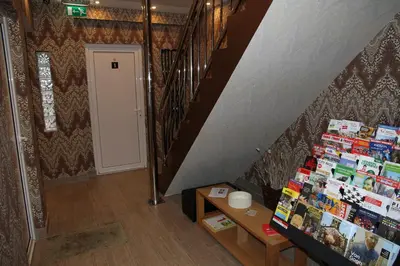 a hallway with a staircase and a book shelf with books at Villa Monte Dana in Zwanenburg