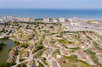 an aerial view of a park next to the ocean at Center Parcs Zandvoort beach in Zandvoort