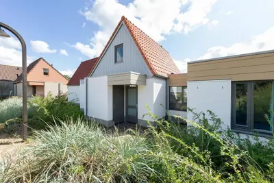 a white house with a red roof at Center Parcs Zandvoort beach in Zandvoort