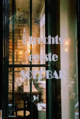 a window with the words yoghurt cookie bar on it at Logement Petit Beijers in Utrecht