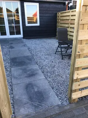 a patio with a chair in front of a house at Bed & Breakfast Aalsmeer in Aalsmeer