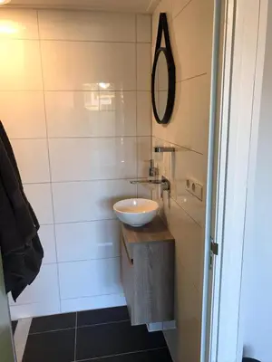 a bathroom with a sink and a mirror at Bed & Breakfast Aalsmeer in Aalsmeer